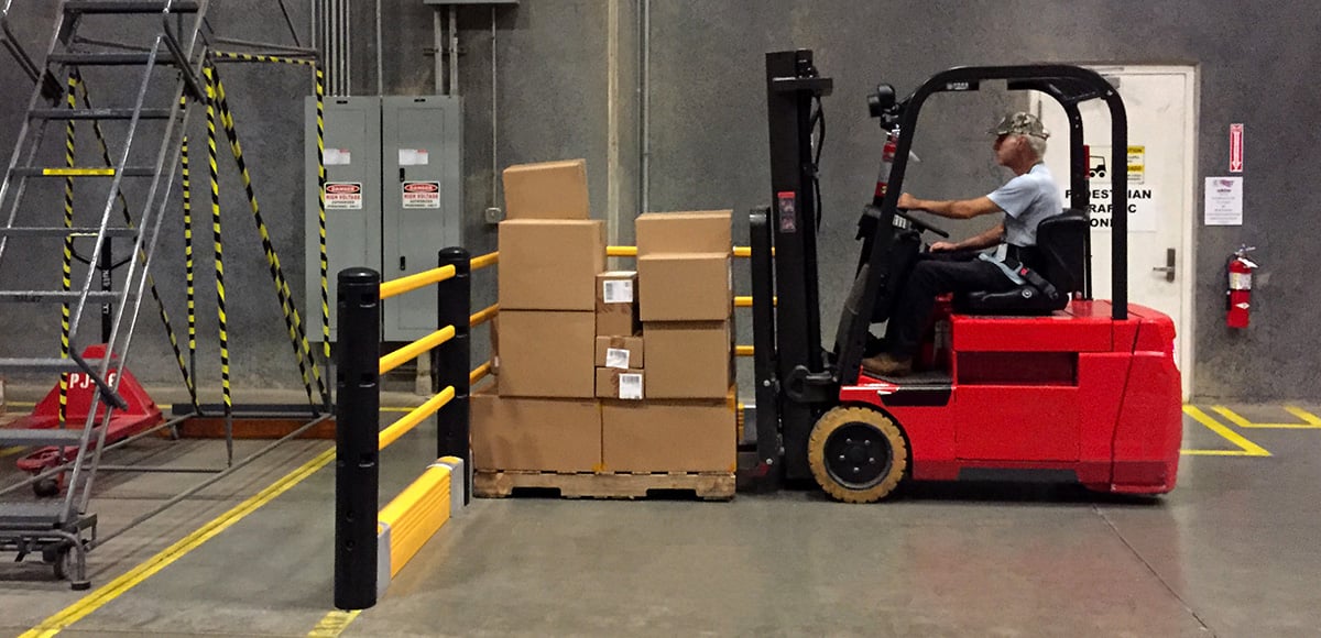 Person driving forklift with boxes hitting a barrier