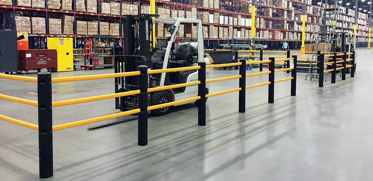 Pedestrian barriers and forklift in warehouse