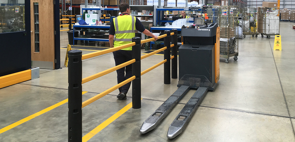 Person Standing Behind Forklift and Barrier