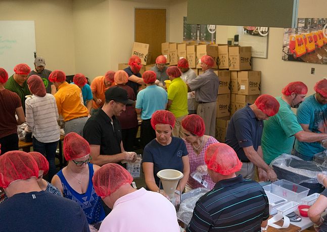 photo of people working in colorful hairnets