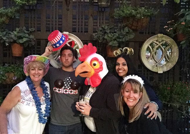 group photo of people wearing silly hats and masks