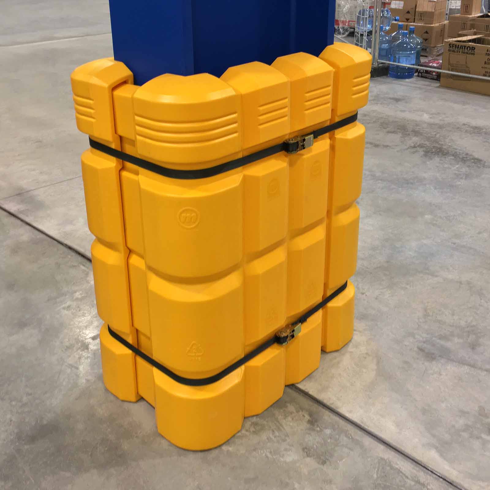 ColumnGuard with extender fitted to a blue steel column, held in place by two black ratchet straps