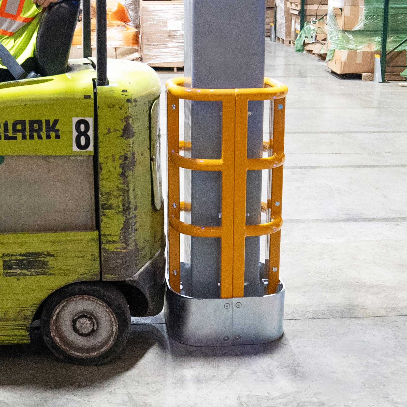 ColumnProtector on a steel column with a forklift pulled up alongside it in a distribution center.