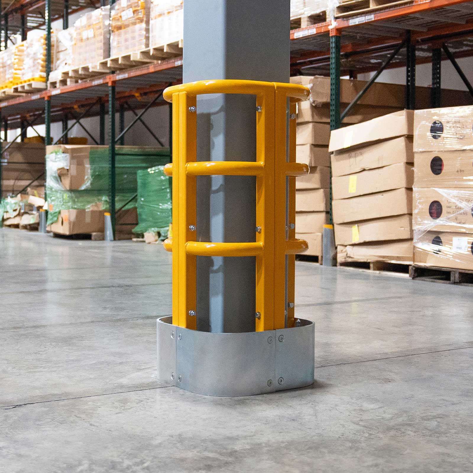ColumnProtector around a steel column in an aisle between pallet racks and stacked cartons.