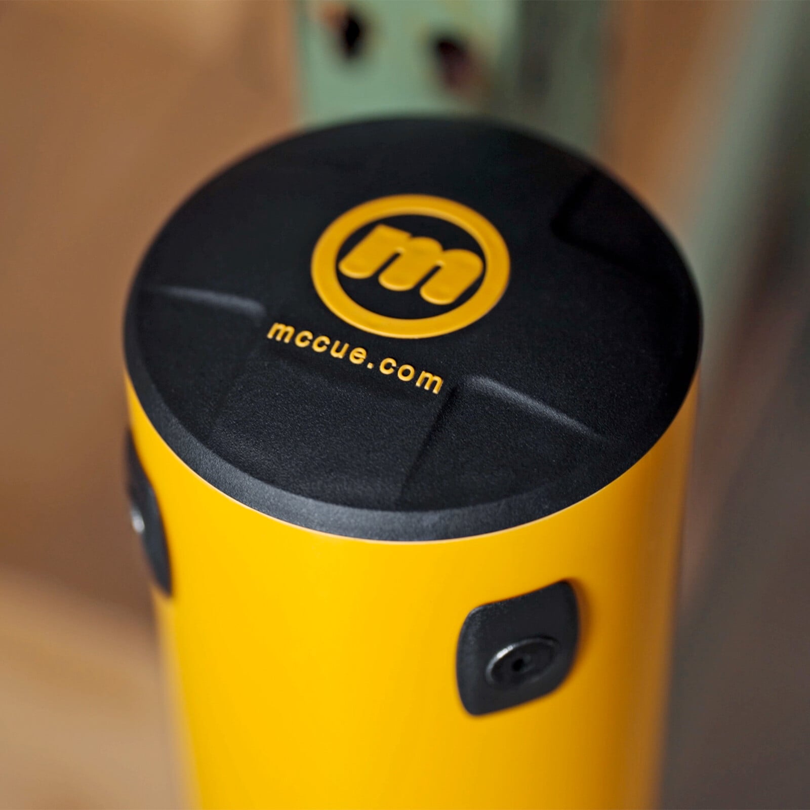 Close-up of the FLEX+ Bollard cap with the McCue logo and mccue.com.