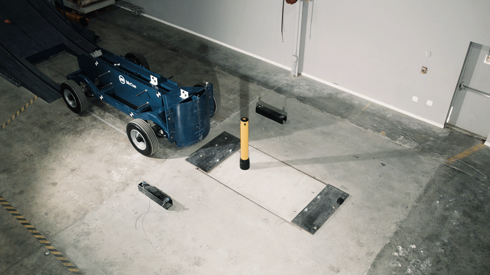 FLEX+ Bollard flexing on impact and returning to form, a surface-mounted flexible bollard for warehouse forklift traffic.