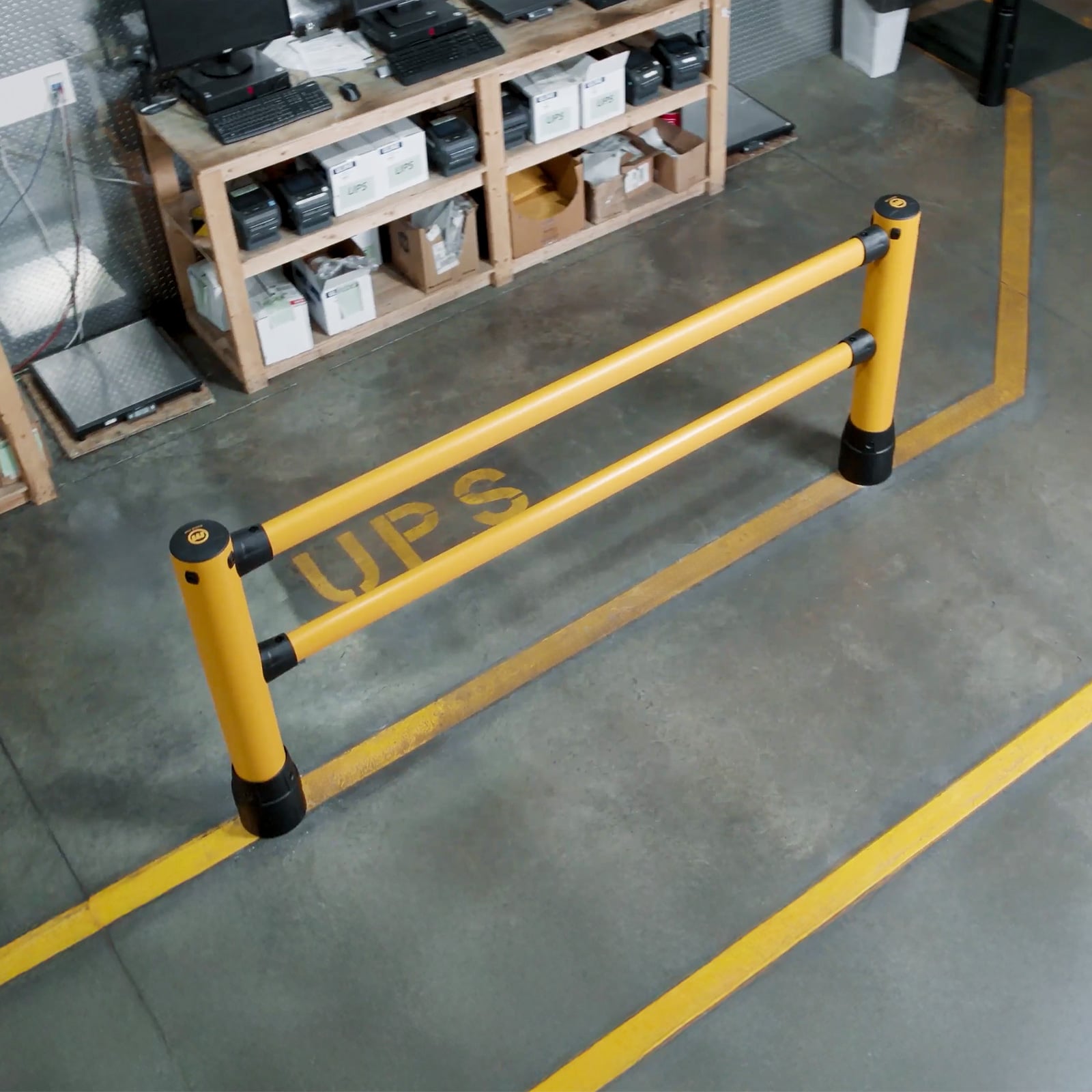 FLEX+ Pedestrian Guard section seen from above beside yellow floor markings in a warehouse shipping area.