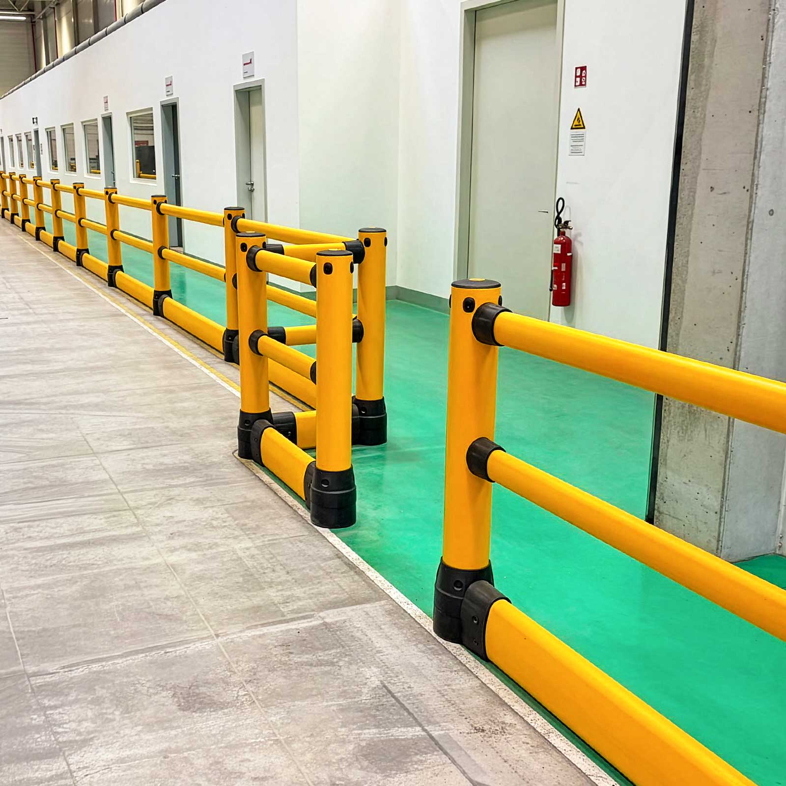 FLEX+ Pedestrian with Ground Guard along a green pedestrian walkway past office doors, with an opening for foot traffic.