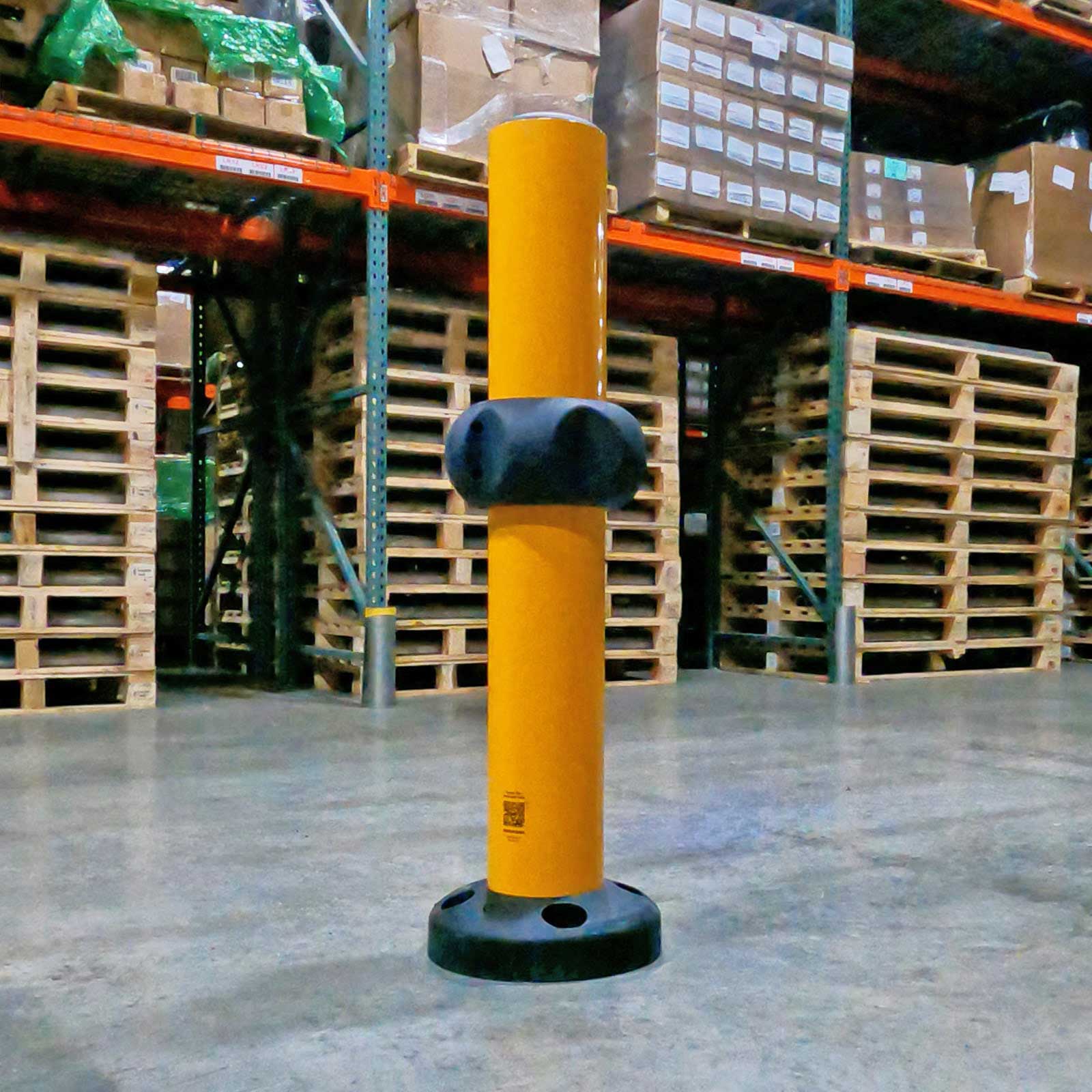 SafeStop Bollard 15 with the Spinner add-on guarding a pallet rack corner in a warehouse.