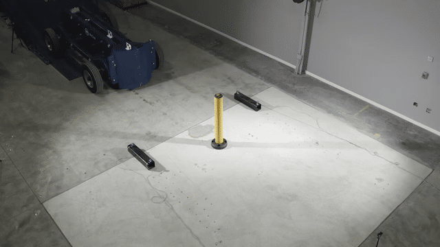 A weighted test vehicle striking a SafeStop Bollard 15 in an impact test as the bollard absorbs the hit.