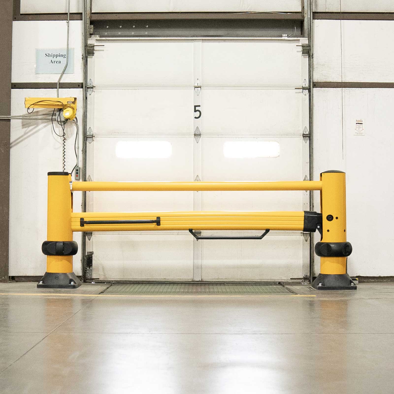 SafeStop ForkLift Gate closed across a shipping dock door, securing the doorway from forklift traffic.