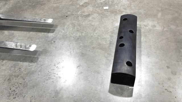 A forklift striking a SafeStop ForkShield floor-mounted barrier in repeated impact tests.