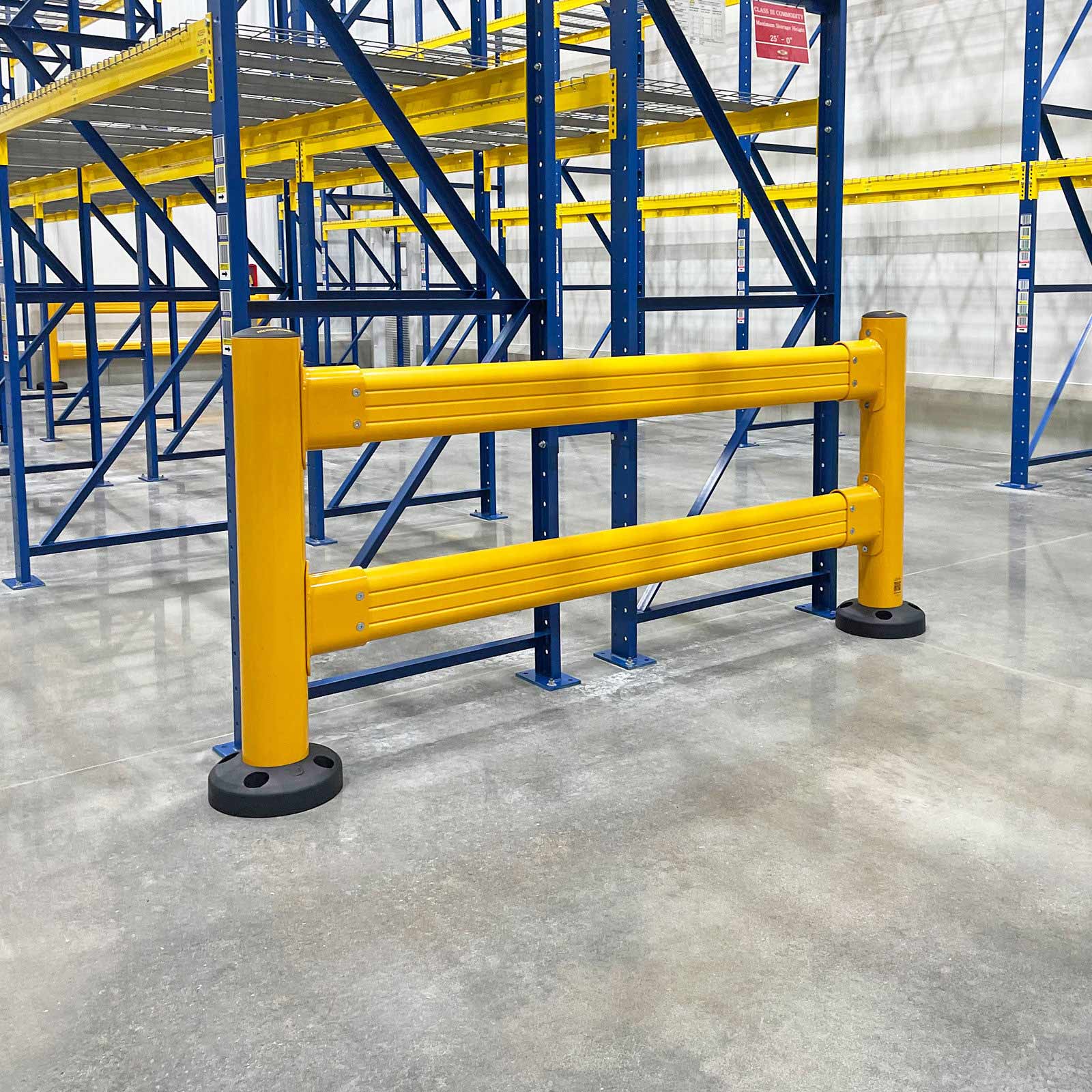 SafeStop GuardRail section protecting the front of blue pallet racking in a warehouse.