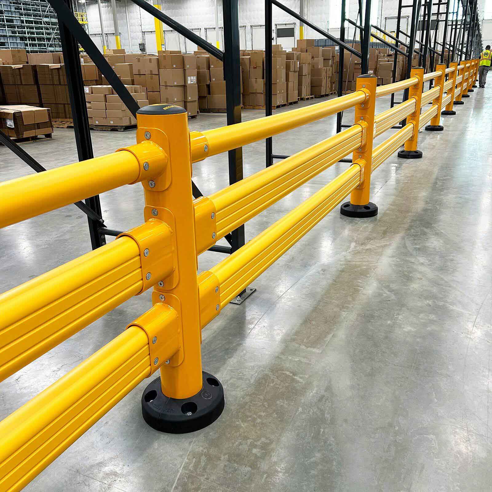 SafeStop Pedestrian GuardRail warehouse pedestrian guardrail running along a racking aisle stacked with cartons.