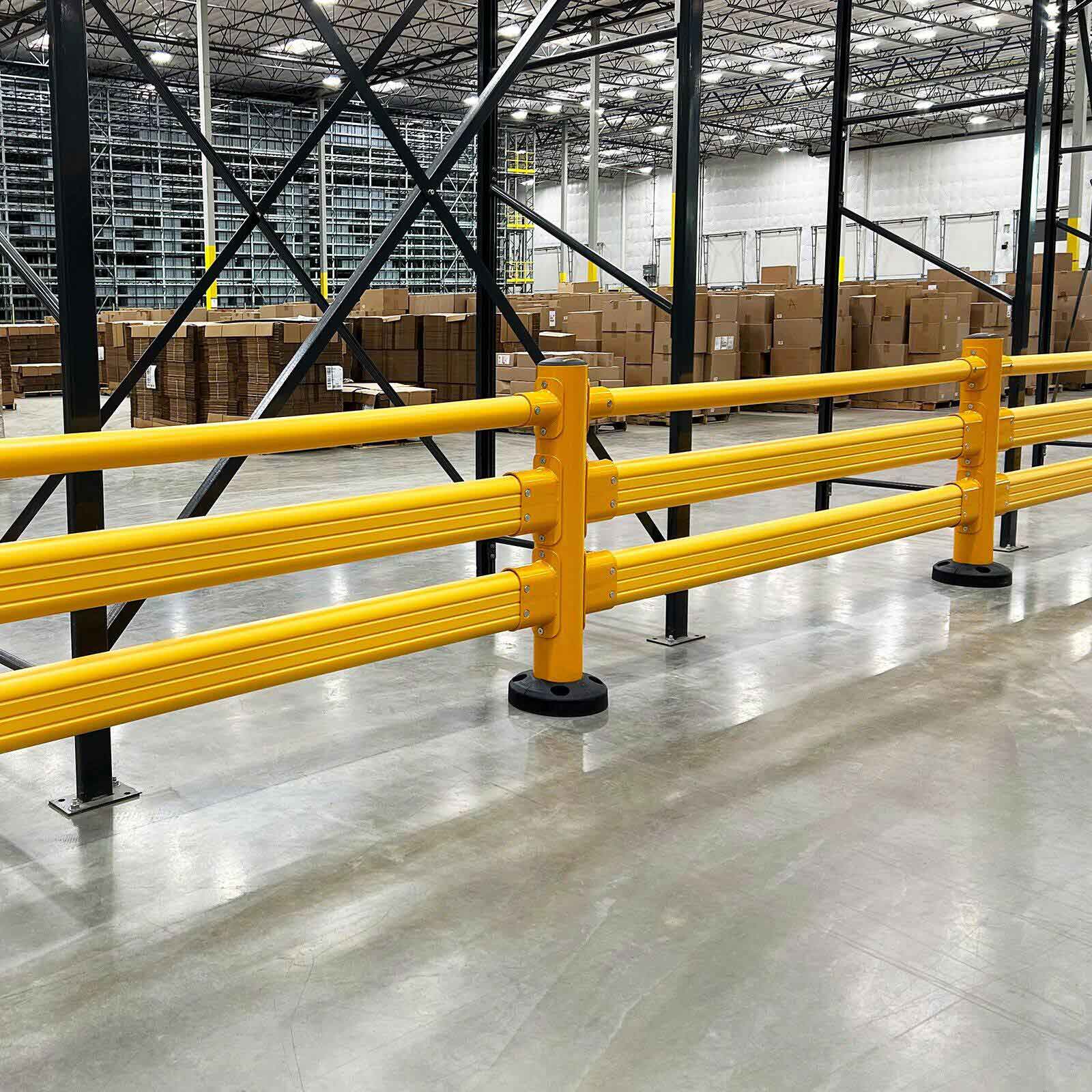 Long run of SafeStop Pedestrian GuardRail in front of pallet racking in a distribution center.