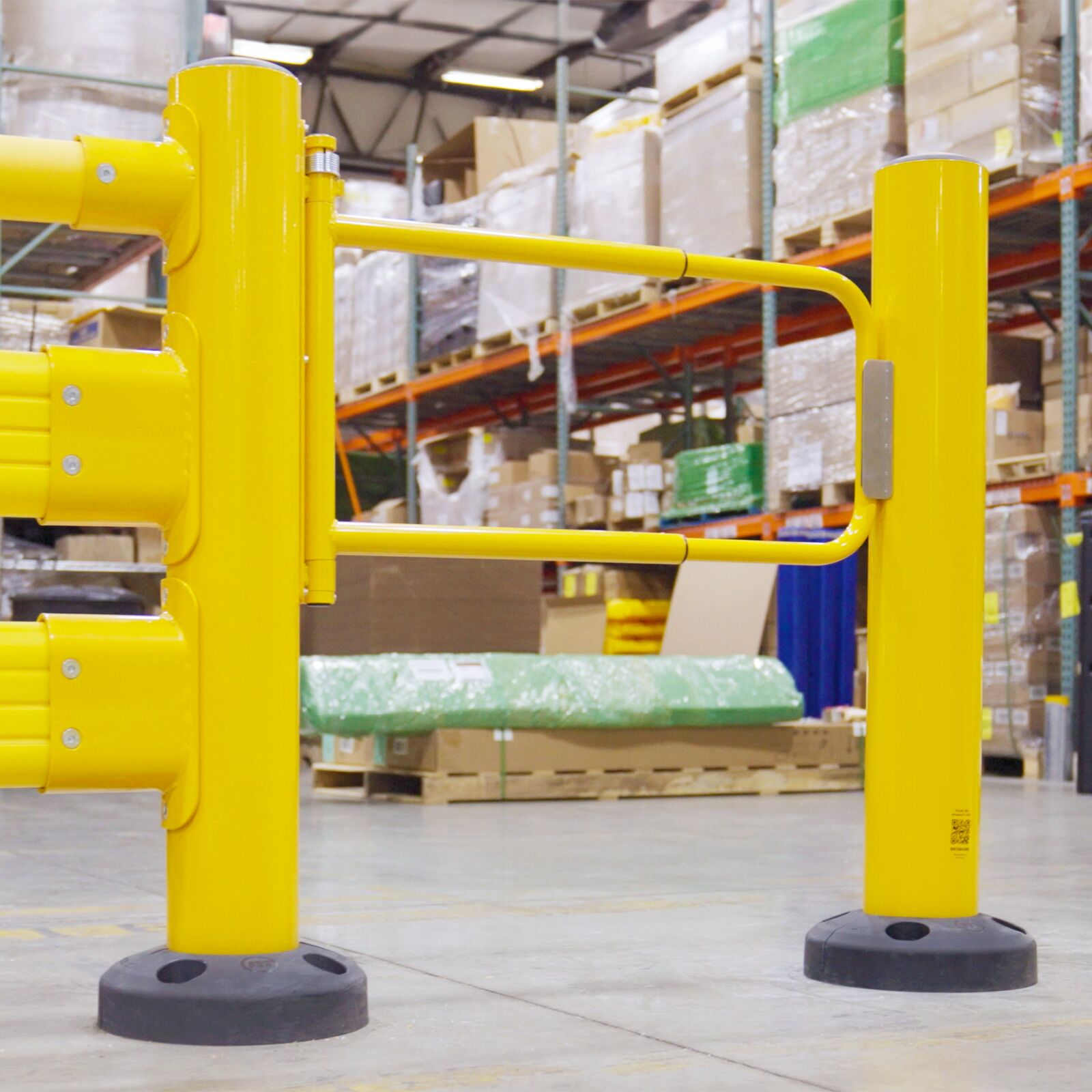 SafeStop Pedestrian GuardRail with a yellow pedestrian swing gate between two posts, racking behind.