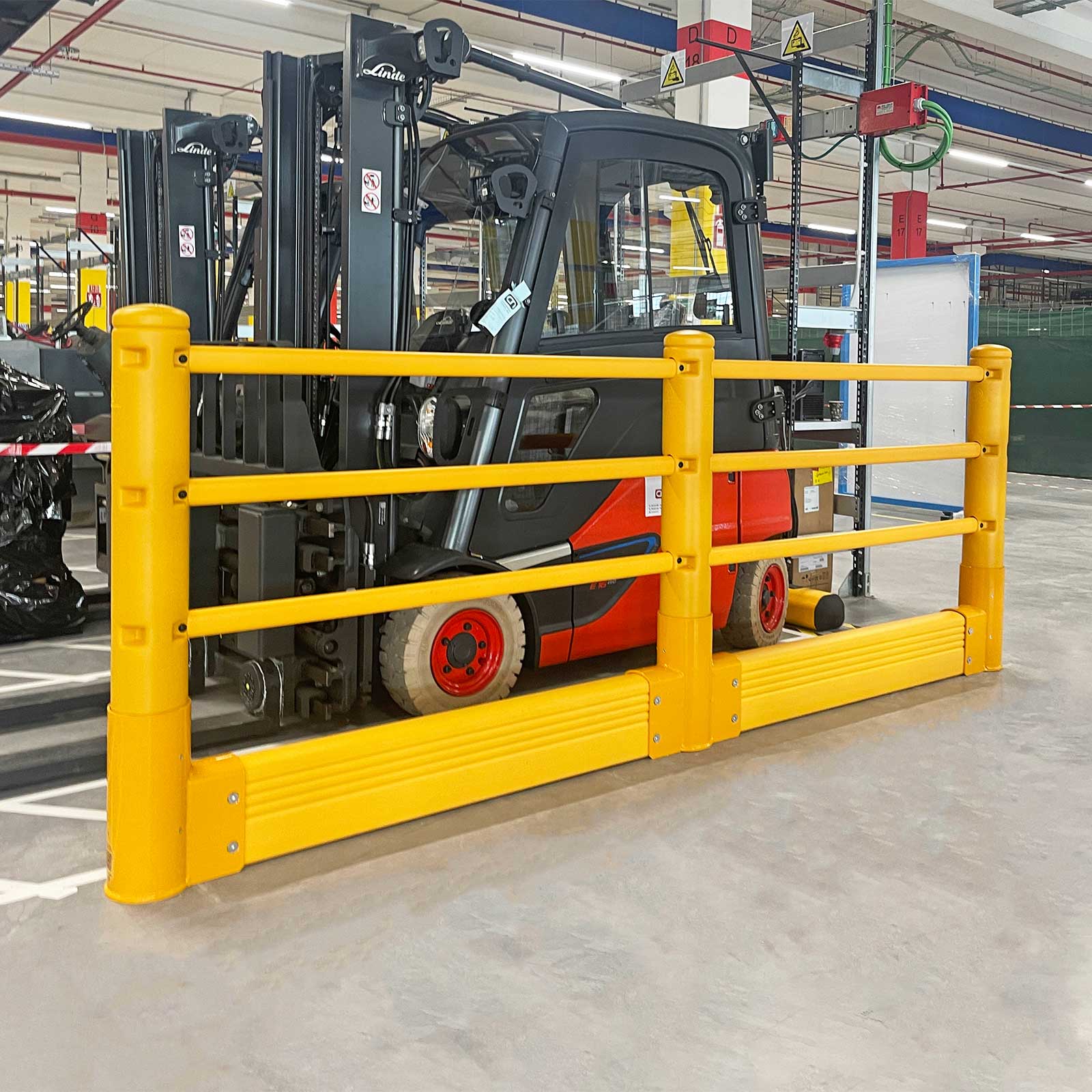 SafeStop Pedestrian with GroundBarrier separating a floor area from a parked red forklift in a warehouse.