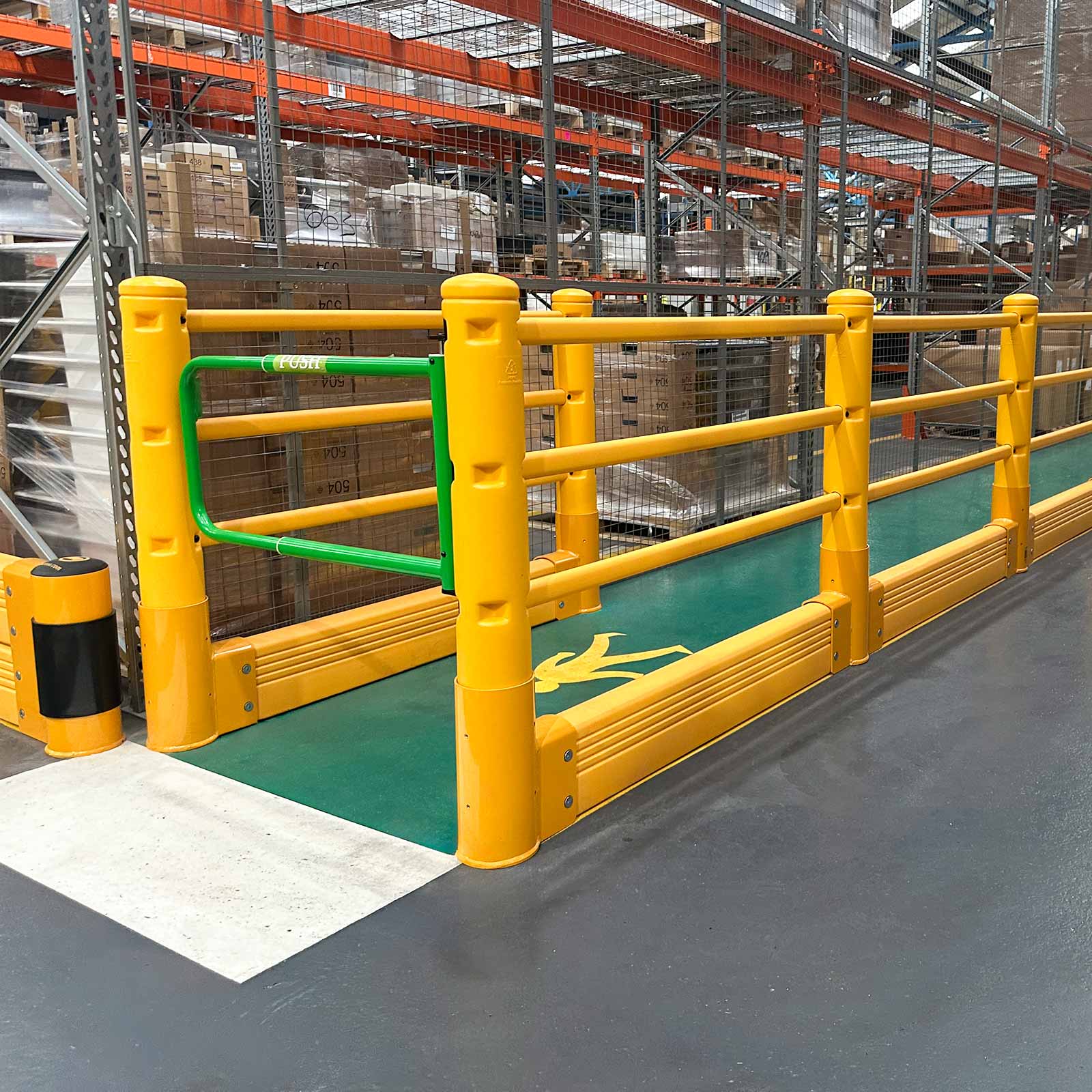 SafeStop Pedestrian with GroundBarrier with a green swing gate opening onto a green pedestrian walkway in a warehouse.
