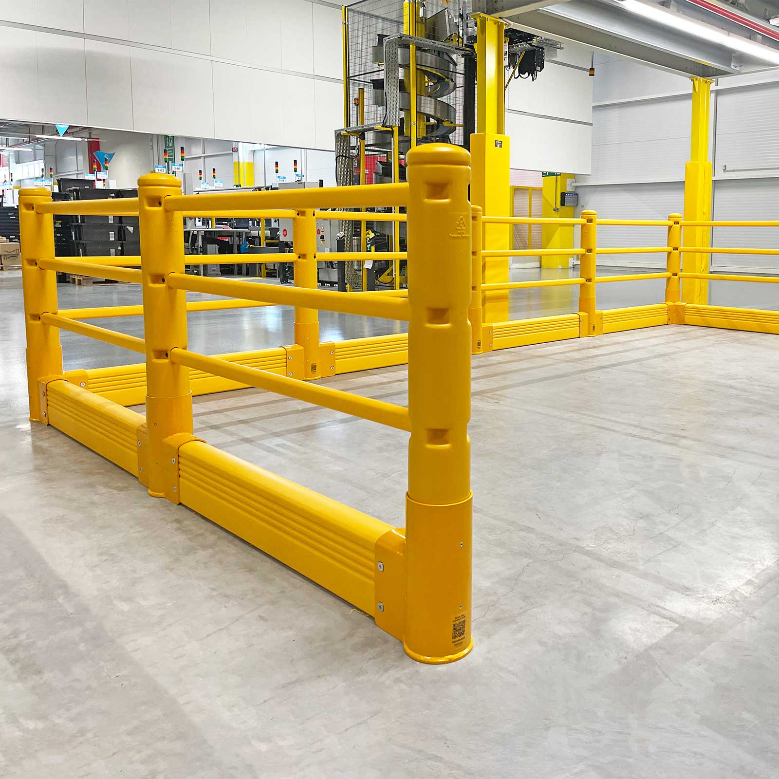 SafeStop Pedestrian with GroundBarrier corner run in front of a caged spiral conveyor in a distribution center.