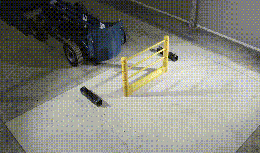 Impact test of a SafeStop Pedestrian with GroundBarrier run as a test vehicle strikes its rails.