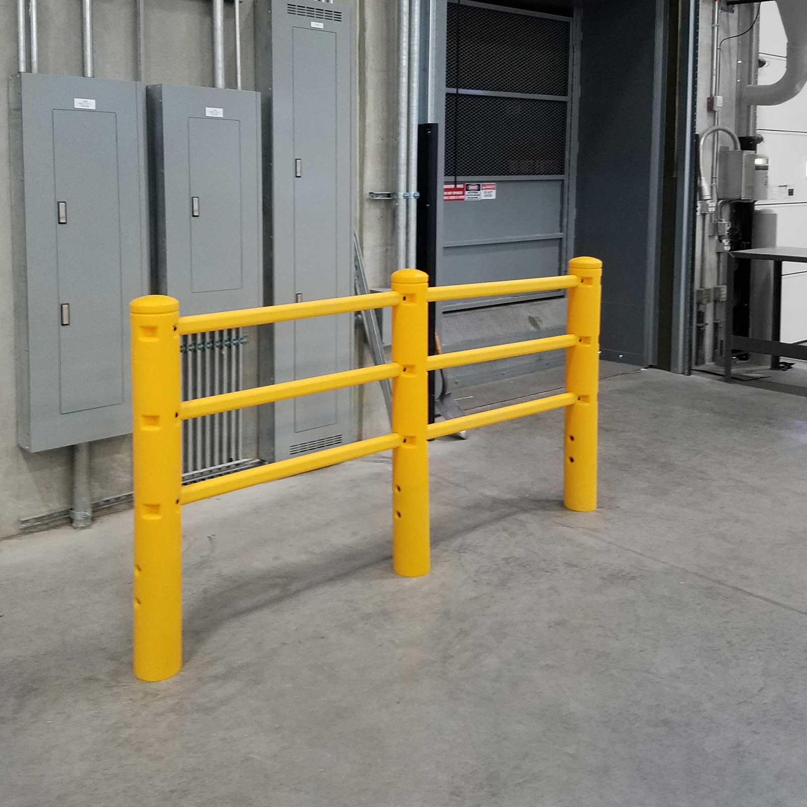 SafeStop PedestrianBarrier guarding wall-mounted electrical panels beside a doorway in a warehouse.