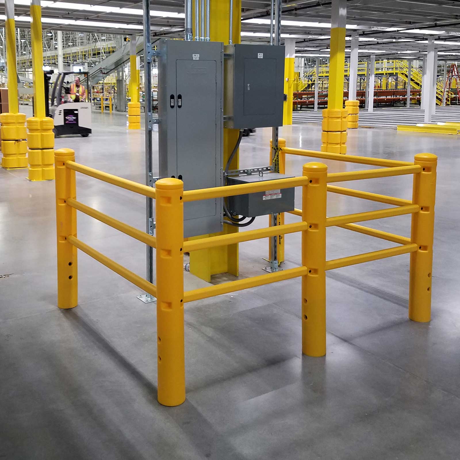 SafeStop PedestrianBarrier enclosing a freestanding electrical cabinet on a warehouse floor.