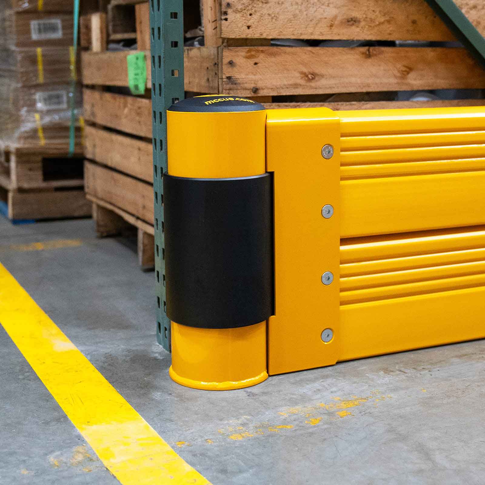 Close-up of a SafeStop RackEnd Protector Double end post with its black spinner, set against a pallet rack upright.