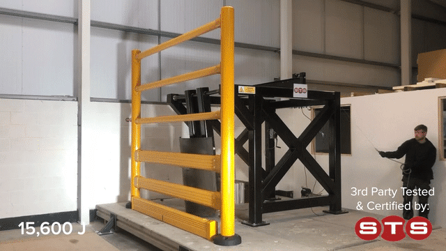 A swing-arm test rig striking a SafeStop ToppleBarrier in a 15,600 joule third-party impact test as the barrier holds.