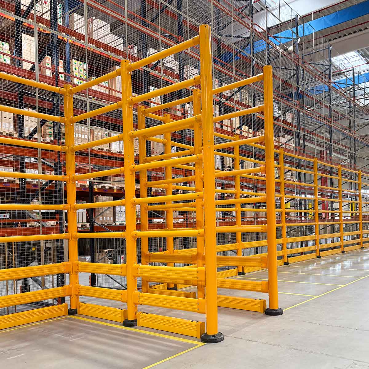 SafeStop ToppleBarrier 176 corner section shielding tall pallet racking from forklift impacts in a warehouse.