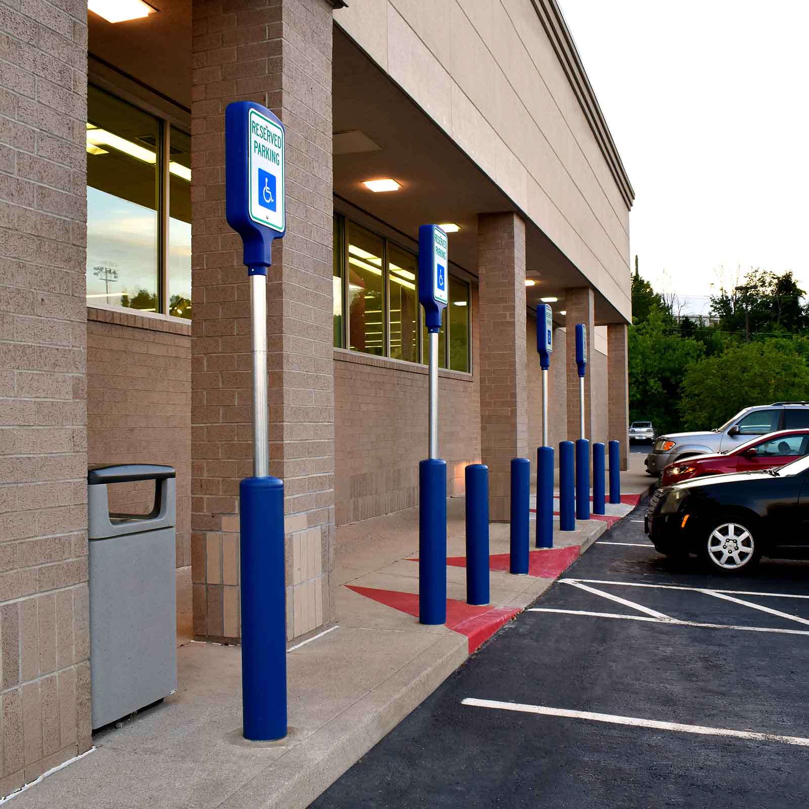 McCue Crash Tested ASTM F3016 CrashCore Bollard with Sign Post in parking lot