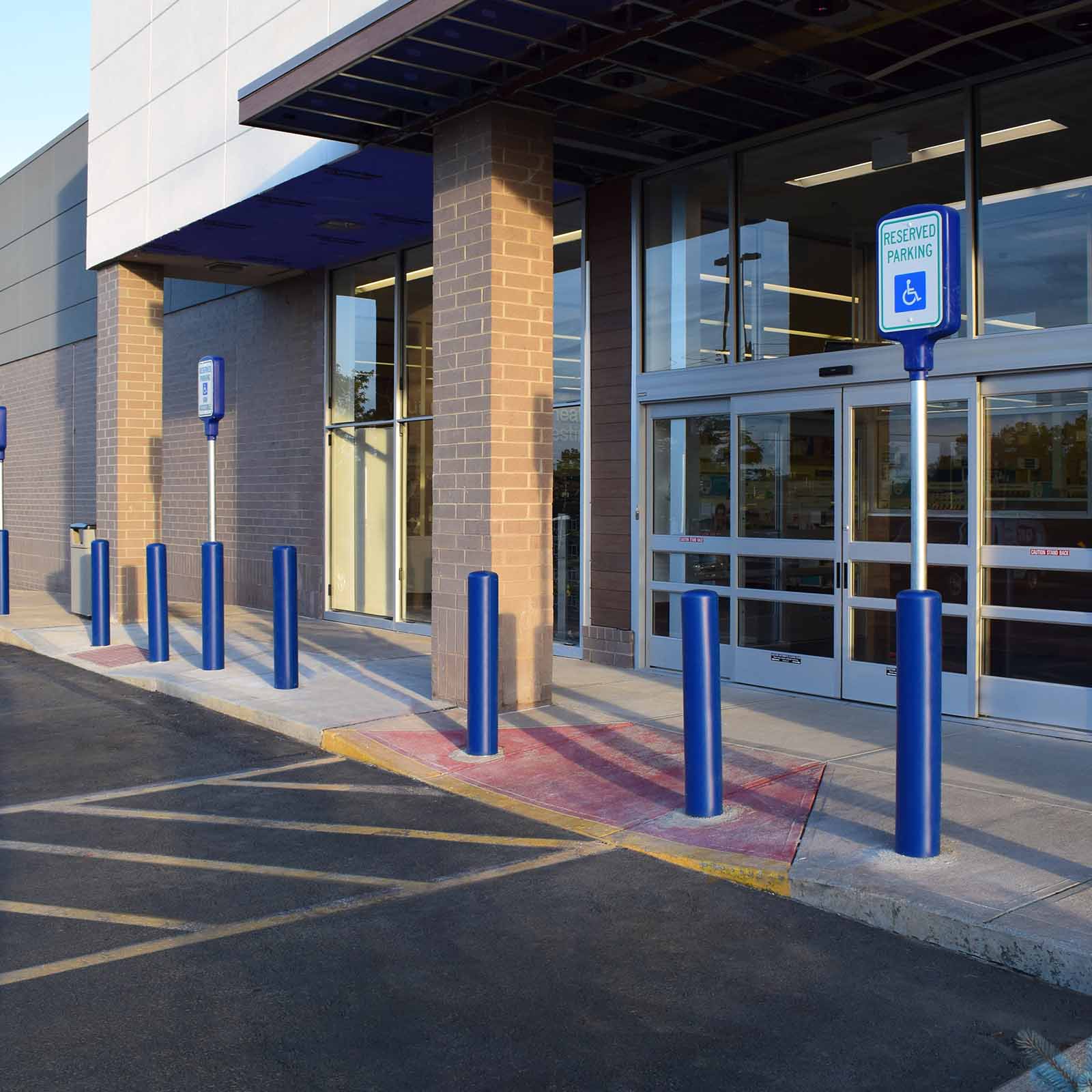 McCue Crash Tested ASTM F3016 CrashCore Bollard with Sign Post in parking lot